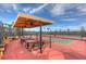 Pickleball courts with shaded seating area at 4946 Sapphire Sound Dr, Wimauma, FL 33598