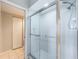 Bathroom featuring tiled floors, a glass-enclosed shower, and a walk-in closet at 6315 Shoreline Dr # 3305, Madeira Beach, FL 33708