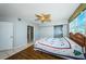 Bright bedroom featuring wood floors, a leaf-themed ceiling fan, and an ensuite bathroom with a glass-enclosed shower at 6315 Shoreline Dr # 3305, Madeira Beach, FL 33708