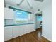 Bedroom with wood floors, built-in cabinets, and a large window with a view of the water at 6315 Shoreline Dr # 3305, Madeira Beach, FL 33708