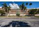 A sunny exterior view of the multi-story condo building with lush landscaping at 6315 Shoreline Dr # 3305, Madeira Beach, FL 33708
