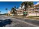 Exterior view of a condo building with palm trees in the parking lot and along the street at 6315 Shoreline Dr # 3305, Madeira Beach, FL 33708
