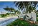 Elegant community entrance sign amidst lush landscaping and tropical palm trees at 6315 Shoreline Dr # 3305, Madeira Beach, FL 33708
