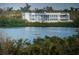 Waterfront home with a modern exterior and views of people kayaking on the water at 6315 Shoreline Dr # 3305, Madeira Beach, FL 33708