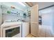 Bright laundry room features a white washer and dryer, shelving and tile floors at 6315 Shoreline Dr # 3305, Madeira Beach, FL 33708