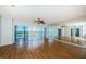 Bright living room with wood floors, ceiling fan, and mirrored wall for an expanded feel at 6315 Shoreline Dr # 3305, Madeira Beach, FL 33708