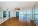 Open living area with wood floors, large windows, and access to the balcony overlooking the water at 6315 Shoreline Dr # 3305, Madeira Beach, FL 33708