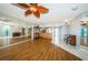 Open concept living area with wood floors, mirrored wall, and kitchen bar seating at 6315 Shoreline Dr # 3305, Madeira Beach, FL 33708