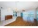Bright living room featuring a mirrored wall, wood floors, and natural light at 6315 Shoreline Dr # 3305, Madeira Beach, FL 33708