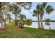Picturesque pond view with mature palms and tranquil seating area in a beautifully maintained community at 6315 Shoreline Dr # 3305, Madeira Beach, FL 33708