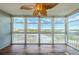 Bright sun room with large windows providing scenic outdoor views and a unique decorative ceiling fan at 6315 Shoreline Dr # 3305, Madeira Beach, FL 33708
