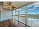 Bright sun room with expansive windows offering scenic outdoor views and a ceiling fan at 6315 Shoreline Dr # 3305, Madeira Beach, FL 33708