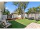 Outdoor backyard with artificial turf, a swing set, a trampoline, and a pergola at 7307 S Mascotte St, Tampa, FL 33616