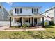 Charming two-story home exterior with front porch, swing, and well-maintained landscaping at 7307 S Mascotte St, Tampa, FL 33616