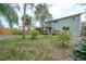 Expansive backyard with a wood fence, green grass, mature trees and a charming two-story deck, perfect for outdoor entertaining at 7692 Harbor View Way, Seminole, FL 33776