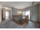 Second-floor hallway with a carpet, striped wallpaper, and access to a bathroom at 7692 Harbor View Way, Seminole, FL 33776