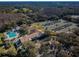 Aerial view of a community featuring a pool, tennis courts, clubhouse and plenty of parking at 9101 Highland Ridge Way, Tampa, FL 33647