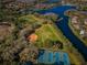 Aerial view of community sports facilities, including baseball field, tennis courts, and sports field near a lake at 9101 Highland Ridge Way, Tampa, FL 33647
