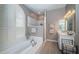 Bright bathroom with a soaking tub, walk-in shower, and stylish vanity at 9101 Highland Ridge Way, Tampa, FL 33647