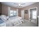 Bright bedroom with a decorative bed, large window, and en-suite bathroom at 9101 Highland Ridge Way, Tampa, FL 33647