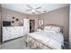 Comfortable bedroom with a white dresser and bed with decorative pillows at 9101 Highland Ridge Way, Tampa, FL 33647