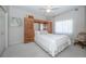 Cozy bedroom featuring neutral decor, a plush bed, and a window with sheer curtains at 9101 Highland Ridge Way, Tampa, FL 33647