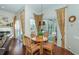 Cozy breakfast nook with a round table and chairs, providing a view of the pool and backyard through sliding glass doors at 9101 Highland Ridge Way, Tampa, FL 33647