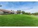 Expansive clubhouse with lush lawn, patio and tree-lined walkway at 9101 Highland Ridge Way, Tampa, FL 33647