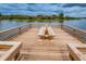 Spacious wooden dock featuring a picnic table, providing a serene spot for relaxing by the water at 9101 Highland Ridge Way, Tampa, FL 33647