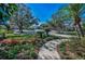 Beautiful landscaping with mature trees and colorful flowers create a welcoming entrance to this charming neighborhood at 9101 Highland Ridge Way, Tampa, FL 33647