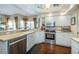 Modern kitchen with stainless steel appliances, sleek countertops, and white cabinets, ideal for cooking and entertaining at 9101 Highland Ridge Way, Tampa, FL 33647