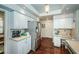 Well-lit kitchen with white cabinetry, stainless steel appliances, and a built-in desk area for added convenience at 9101 Highland Ridge Way, Tampa, FL 33647