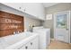 Well-equipped laundry room with a large sink, modern washer/dryer, and ample cabinet space at 9101 Highland Ridge Way, Tampa, FL 33647