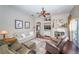 Inviting living room with a fireplace, hardwood floors, ceiling fan, and access to the pool area at 9101 Highland Ridge Way, Tampa, FL 33647