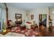 Bright living room featuring hardwood floors, tasteful furnishings, and access to other areas of the home at 9101 Highland Ridge Way, Tampa, FL 33647