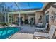 Beautiful screened-in patio with a pool and plenty of seating at 9101 Highland Ridge Way, Tampa, FL 33647