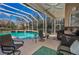 Inviting screened-in pool area featuring comfortable seating and an outdoor bar at 9101 Highland Ridge Way, Tampa, FL 33647