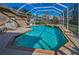 Screened-in pool featuring tile accents, a brick trim, and an attached spa at 9101 Highland Ridge Way, Tampa, FL 33647