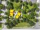 An aerial view shows a vibrant neighborhood park with playground and picnic areas, surrounded by lush greenery at 9645 Little Bluestem Dr, Land O Lakes, FL 34637