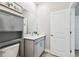 Half-bath featuring gray vanity with white countertop and gray storage cabinet at 9645 Little Bluestem Dr, Land O Lakes, FL 34637