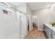 Bright and open bathroom featuring a modern glass shower and wood-style flooring at 9645 Little Bluestem Dr, Land O Lakes, FL 34637