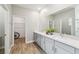 Spacious bathroom with double vanity, modern fixtures, large mirror and walk-in closet at 9645 Little Bluestem Dr, Land O Lakes, FL 34637