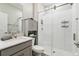 Bathroom featuring glass-enclosed shower and gray vanity with storage at 9645 Little Bluestem Dr, Land O Lakes, FL 34637