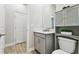 Half-bath with gray vanity, quartz countertop and tiled floor at 9645 Little Bluestem Dr, Land O Lakes, FL 34637