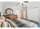 Bedroom featuring decorative mirror and wood dresser with closet and bed with throw pillows at 9645 Little Bluestem Dr, Land O Lakes, FL 34637