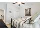Cozy bedroom featuring ceiling fan, closet and warm neutral colors at 9645 Little Bluestem Dr, Land O Lakes, FL 34637