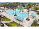 The community pool features a spacious deck, plenty of seating, palm trees, and kid-friendly water features at 9645 Little Bluestem Dr, Land O Lakes, FL 34637