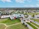 Aerial view of a community pool and amenity center in a residential neighborhood at 9645 Little Bluestem Dr, Land O Lakes, FL 34637