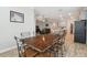 Open concept floor plan showcasing the dining room with a wooden table and black chairs at 9645 Little Bluestem Dr, Land O Lakes, FL 34637