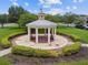 Aerial view of a gazebo with surrounding landscaping and trees at 9645 Little Bluestem Dr, Land O Lakes, FL 34637